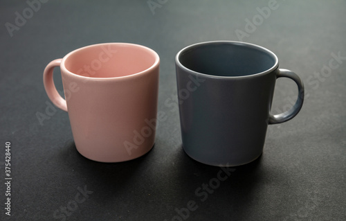 Coffee mugs pink and grey color on black background. Hot beverage cup mockup template