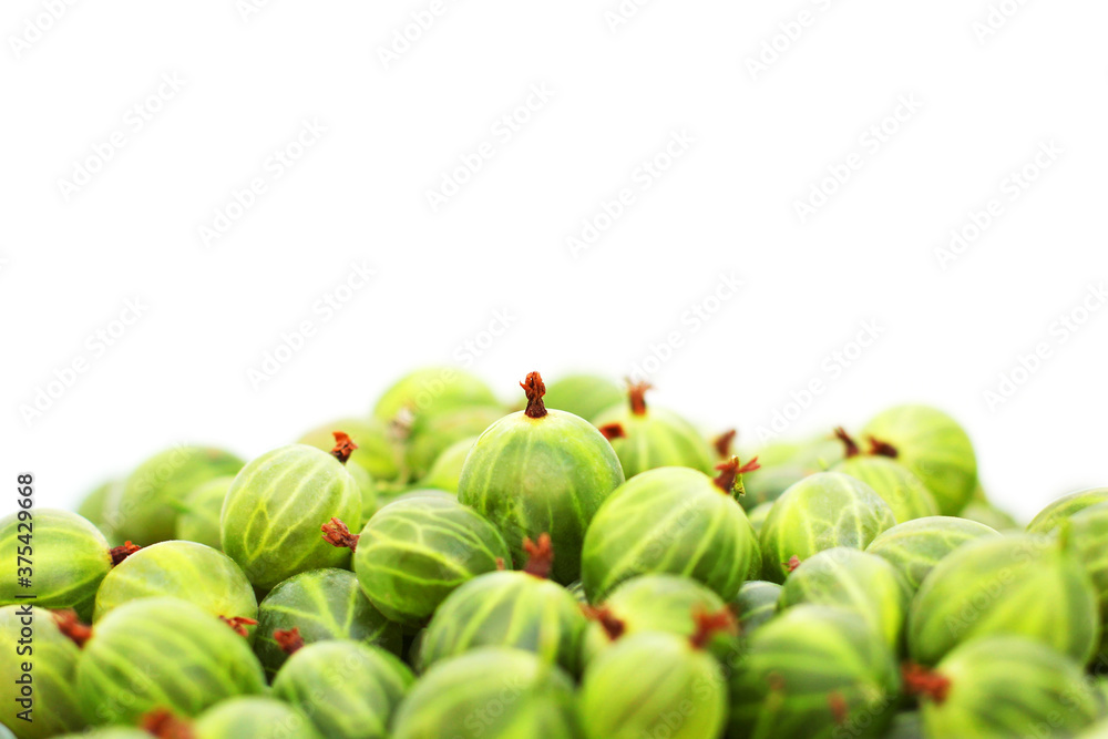 Gooseberries on a white plate close-up. Ripe gooseberries. Green