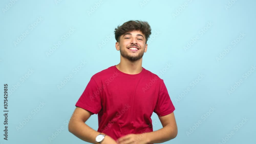 Young arab man expression of confidence and emotion, fun and friendly, showing tongue as a sign of play or fun Young arab man expression of confidence and emotion, fun and friendly, showing tongue as a sign of play or fun