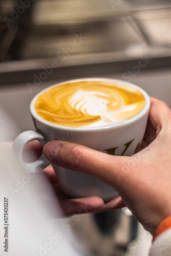close up of a cup of coffee in hands