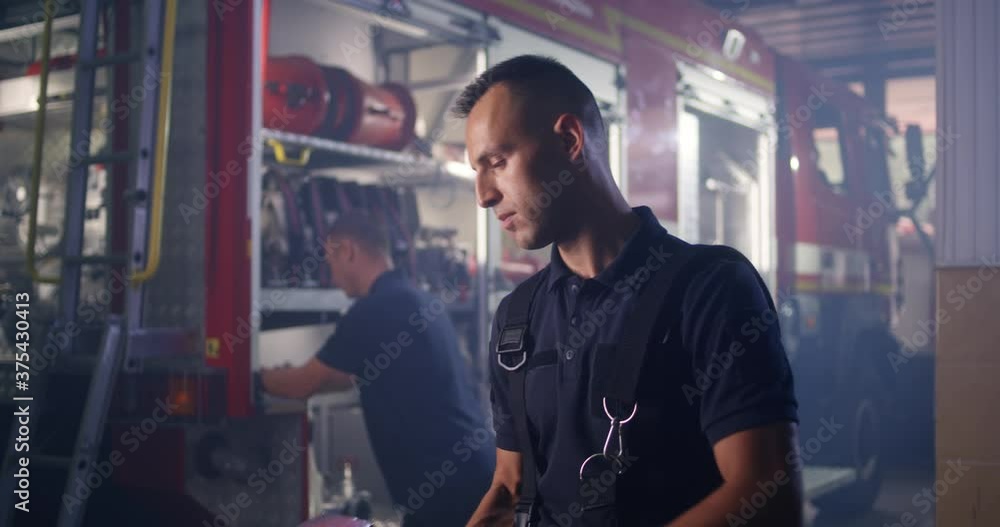 Fireman cleaning axe during work Fireman cleaning axe during work