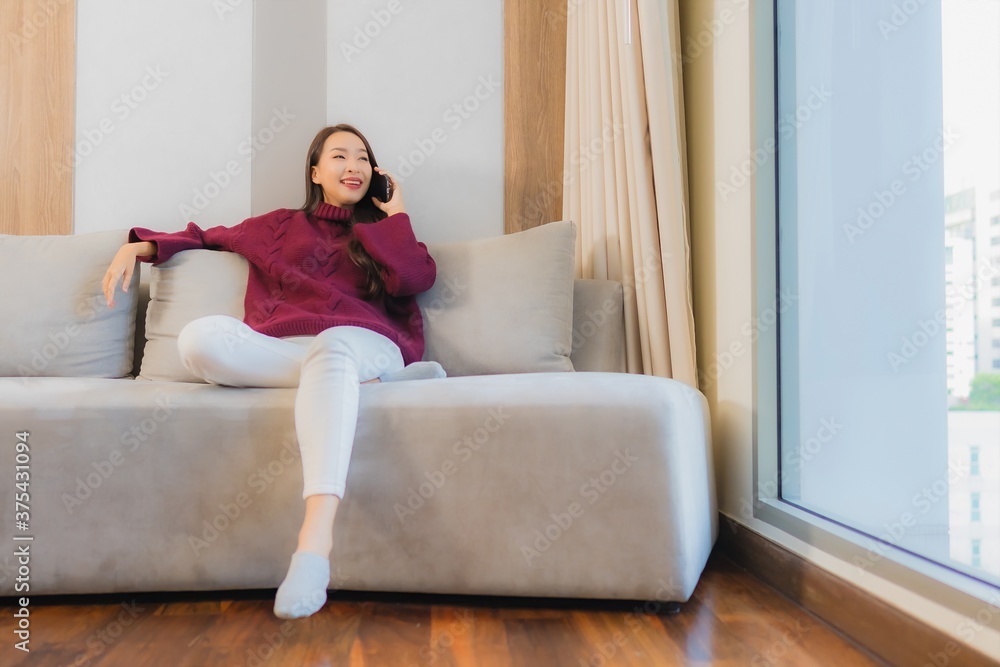 Portrait beautiful young asian woman use smart mobile phone on sofa Portrait beautiful young asian woman use smart mobile phone on sofa