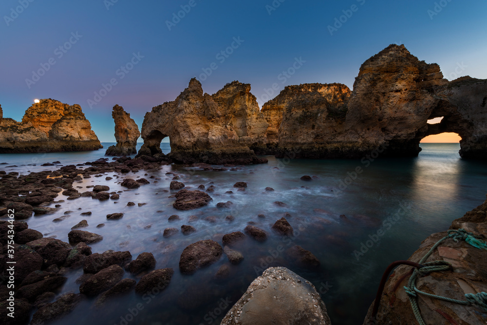 Fototapeta premium View of the beautiful rock formations at the Ponta da Piedade, near the city of Lagos, Algarve, at dusk; Concept for travel in Portugal