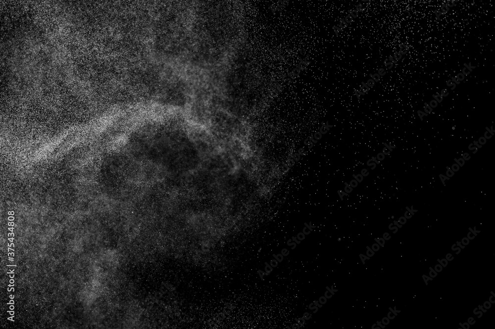 Abstract splashes of water on black background. Freeze motion of white particles. Rain, snow overlay texture.