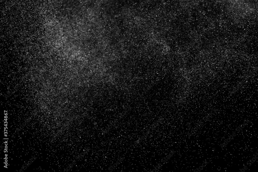 Abstract splashes of water on black background. Freeze motion of white particles. Rain, snow overlay texture. Abstract splashes of water on black background. Freeze motion of white particles. Rain, snow overlay texture.