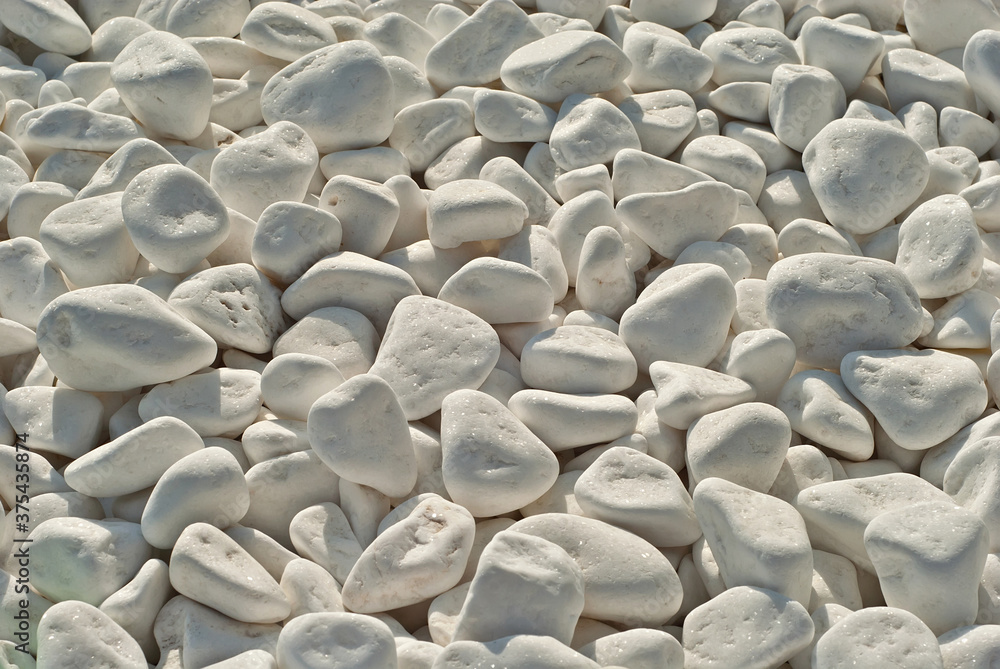 Obraz premium Drainage systems from small pebbles. Garden drainage for plants and trees. White stones for roads and flower beds.
