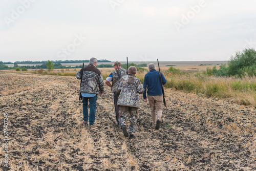 Fotografie Group of hunters going on the hunting. Autumn season concept