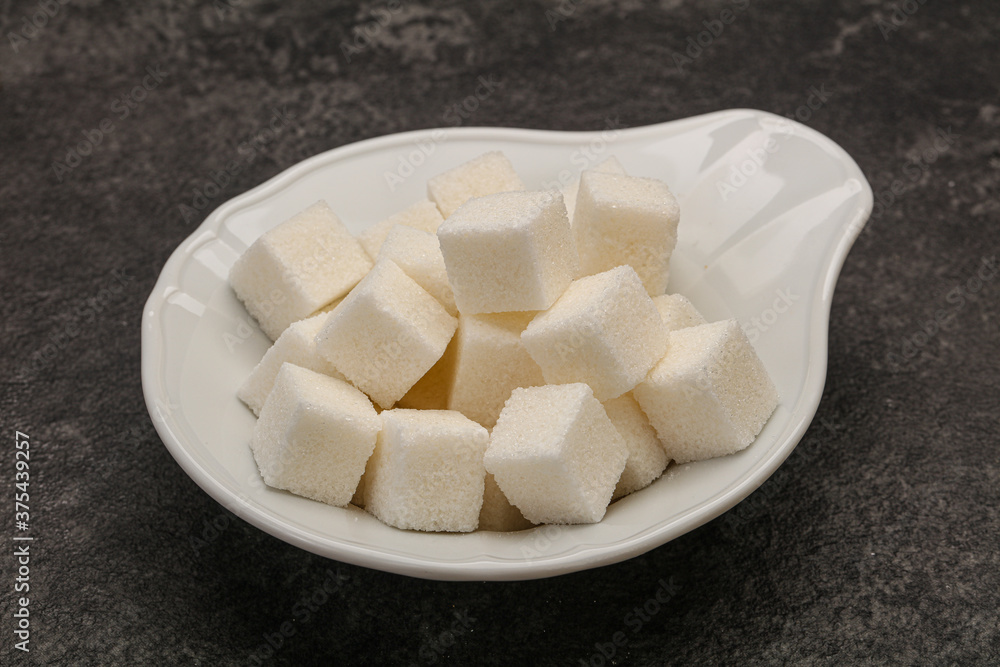 Refined white sugar cubs in the bowl Refined white sugar cubs in the bowl