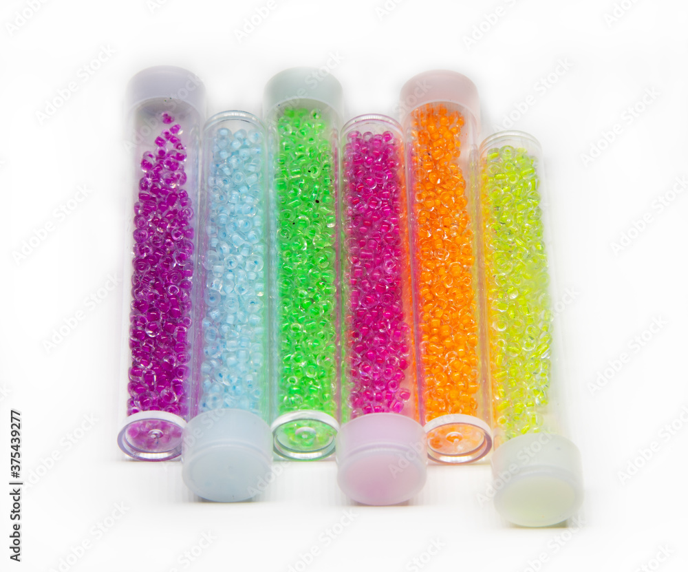 several jars with multi-colored beads several jars with multi-colored beads