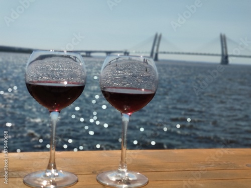 Glass of wine on the background of the bridge in St. Petersburg, Russia © Denis