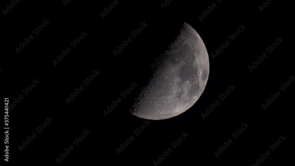 Moon has reached the first quarter , half moon with shadows close Moon has reached the first quarter , half moon with shadows close