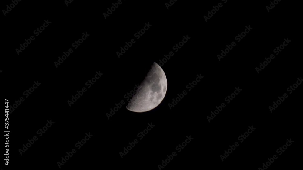 Zooming out of the beautiful moon , half moon surface illuminated , first Quarter Moon phase Zooming out of the beautiful moon , half moon surface illuminated , first Quarter Moon phase