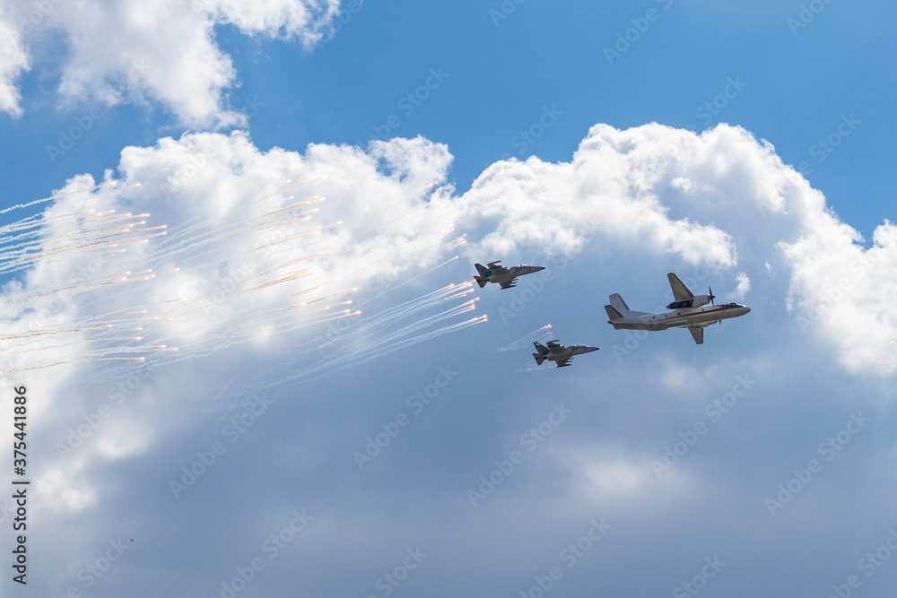 Fototapeta premium Daylight. large aircraft accompanied by combat vehicles. blue sky