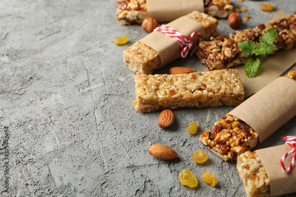 Tasty granola bars on gray background, space for text Tasty granola bars on gray background, space for text