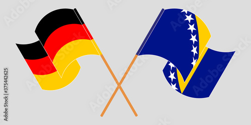Crossed and waving flags of Germany and Bosnia and Herzegovina