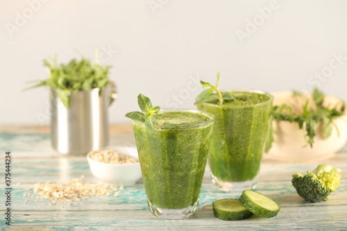 a green smoothie is on the table next to healthy foods photo