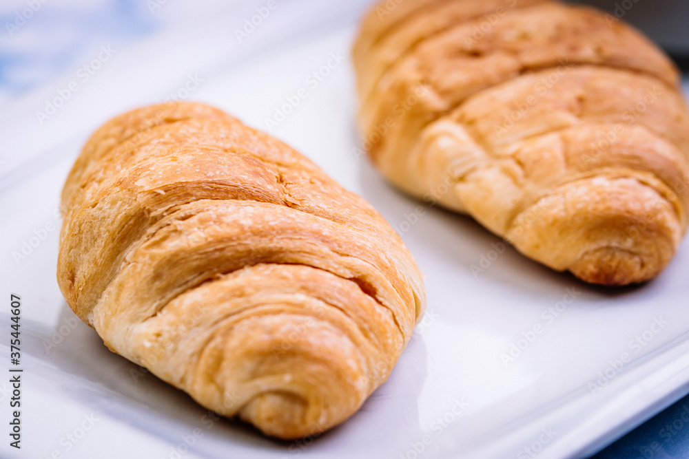 Close-up of breakfast consisting of croissants with white crockery. Close-up of breakfast consisting of croissants with white crockery.