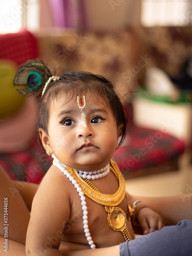 Cute baby dressed up like lord krishna/gopal in the occasion of janmashtami  stock image. Stock Photo | Adobe Stock