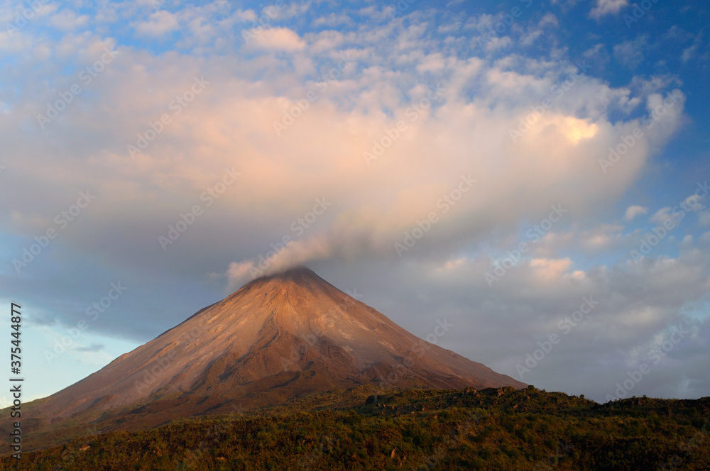 Cloud expanding from smoke of Arenal Volcano Costa Rica at sunset