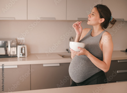 pregnant woman in kitchen (ID: 375448473)