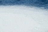 White snow texture on blue ice, winter background