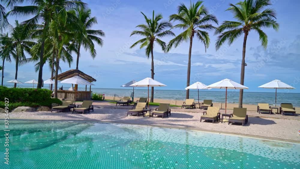 Beautiful umbrella and chair around swimming pool in hotel and resort - vacation concept Beautiful umbrella and chair around swimming pool in hotel and resort - vacation concept