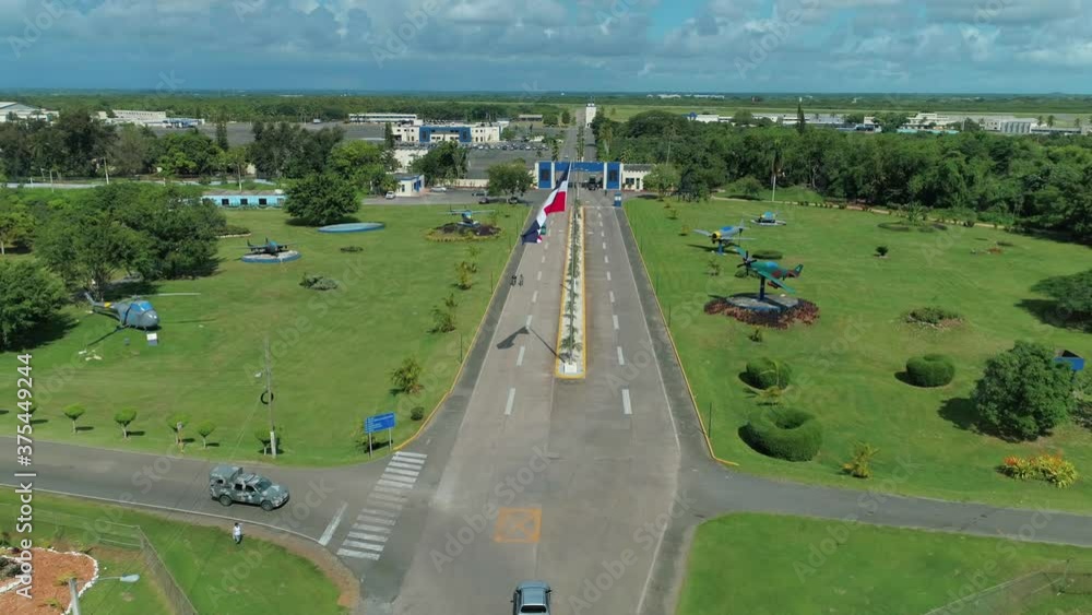 Entrance of the military air base of san isidro, dominican republic, flag waving on a clear day, shot with drone Entrance of the military air base of san isidro, dominican republic, flag waving on a clear day, shot with drone