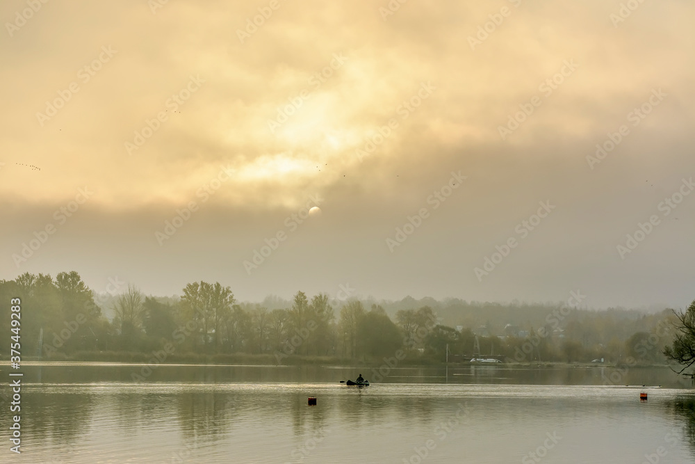 Foggy morning on the beach located on the shore  lake.