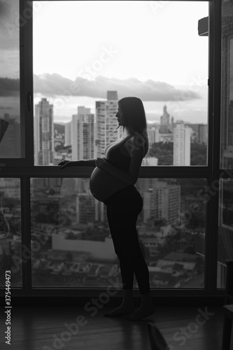 silhouette of a pregnant woman - background building (ID: 375449473)
