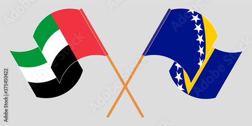 Crossed and waving flags of the United Arab Emirates and Bosnia and Herzegovina