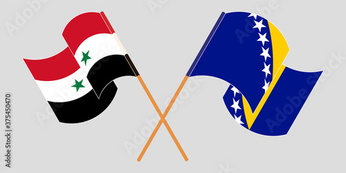 Crossed and waving flags of Syria and Bosnia and Herzegovina