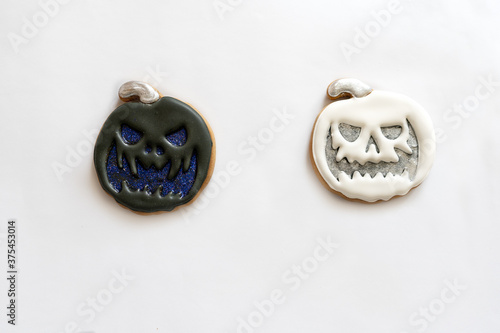 Halloween holiday concept. Sweet gingerbread pumpkin of black and white color. Layout top view