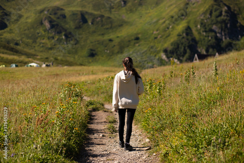 Girl Hiking in the mountains, enjoying nature, trekking, active sports