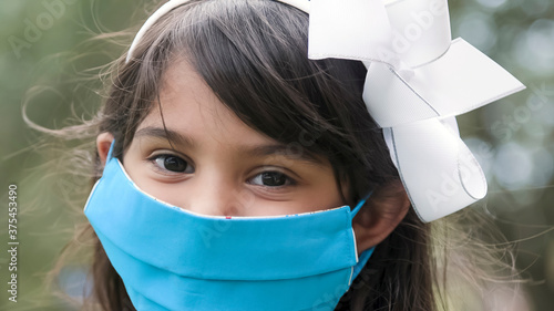 Happy child inspite of having to wear a mask during pandemic photo