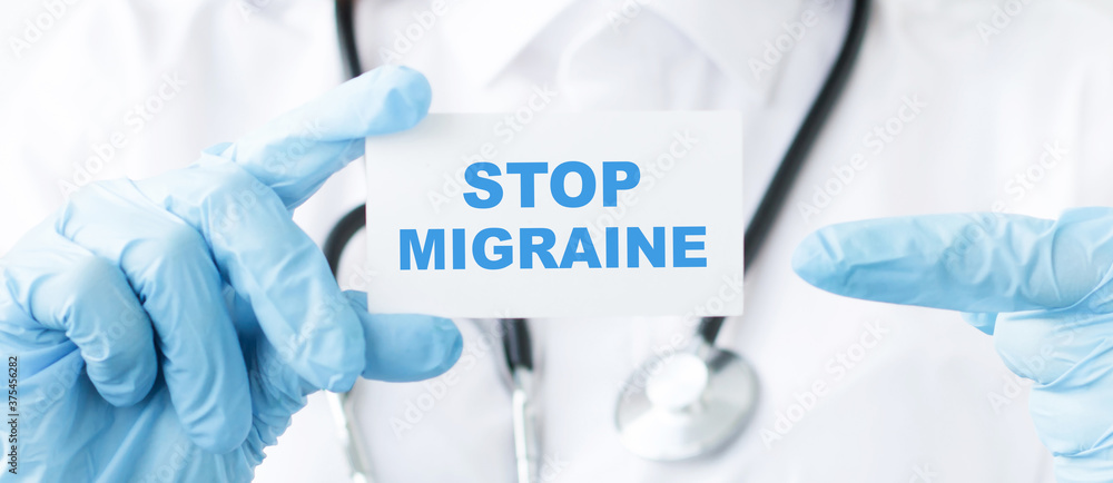 Doctor holding a card with Stop Migraine, medical concept Doctor holding a card with Stop Migraine, medical concept
