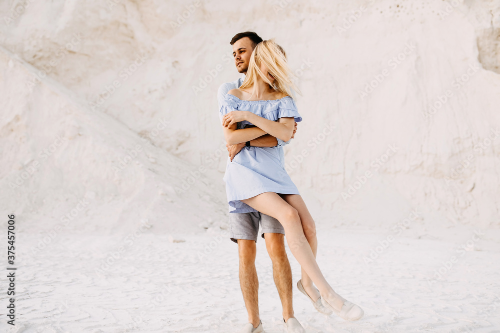 Young romantic couple outdoors having fun. Man spinning woman, smiling. Young romantic couple outdoors having fun. Man spinning woman, smiling.