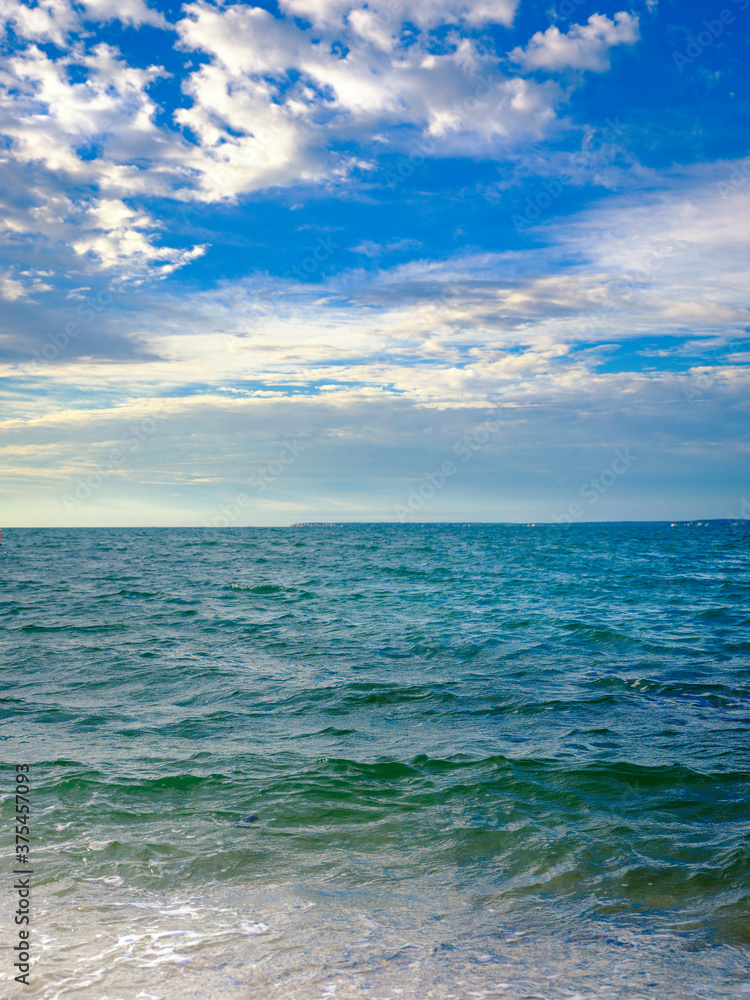 Tranquil seascape with cumulus clouds over the waves in the ocean Tranquil seascape with cumulus clouds over the waves in the ocean