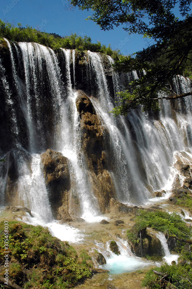 Obraz premium Juizhaigou (Nine Villages Valley) in Sichuan, China. View of Nuorilang Waterfall. Juizhaigou is a popular tourist destination in China famous for its waterfalls, lakes and scenic beauty.