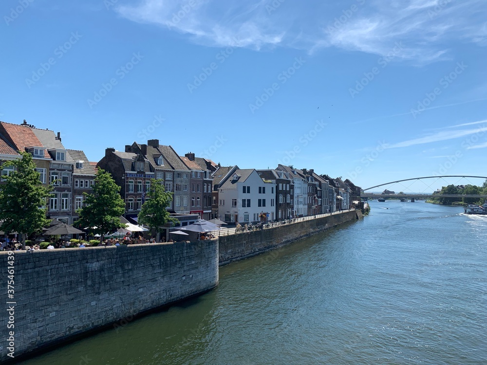 Old houses on the bank of Meuse (Maas) river. Maastricht, Limburg / Netherlands .