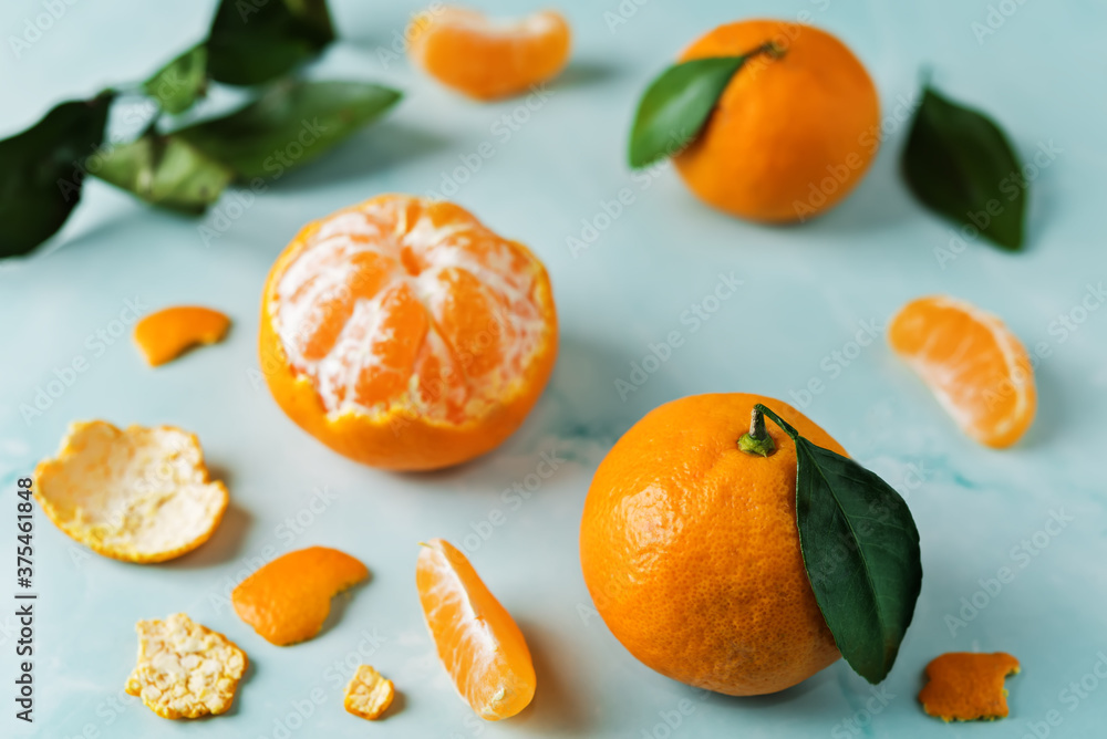 Tangerine fruit with slices, peel and leaves Tangerine fruit with slices, peel and leaves