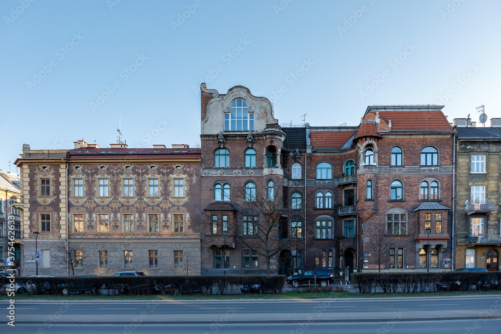 Facades of residential old buildings with beautiful molding and balconies on Krakow street, Poland