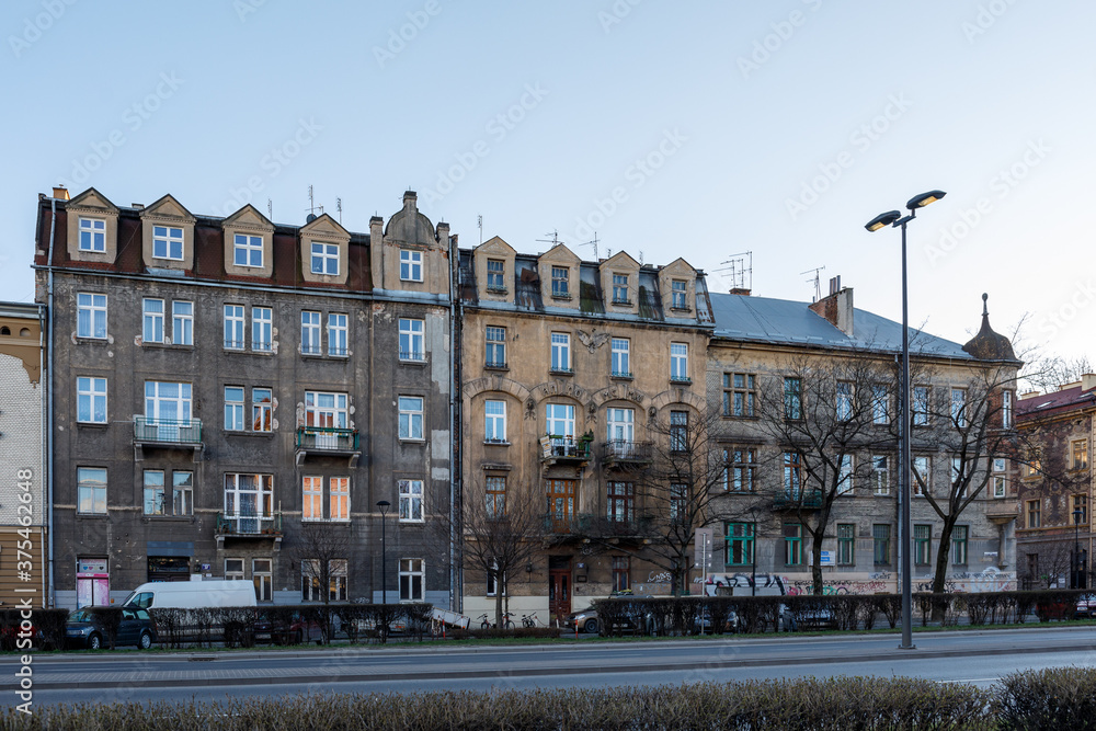 Facades of residential old buildings with beautiful molding and balconies on Krakow street, Poland
