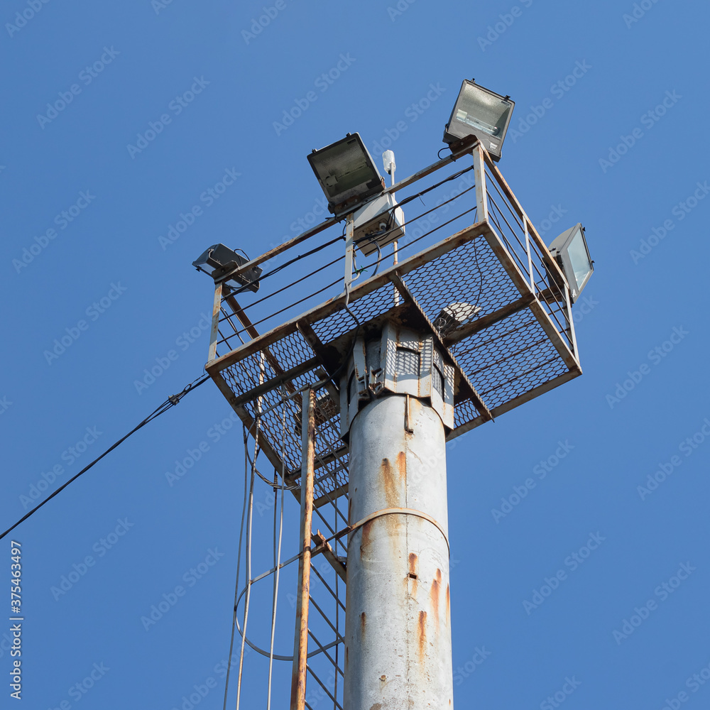 The Observation Floodlight Platform Is Installed On a Pole. The Ladder for Ascent and Descent Is Visible, As Well as The Power Supply Cable The Observation Floodlight Platform Is Installed On a Pole. The Ladder for Ascent and Descent Is Visible, As Well as The Power Supply Cable