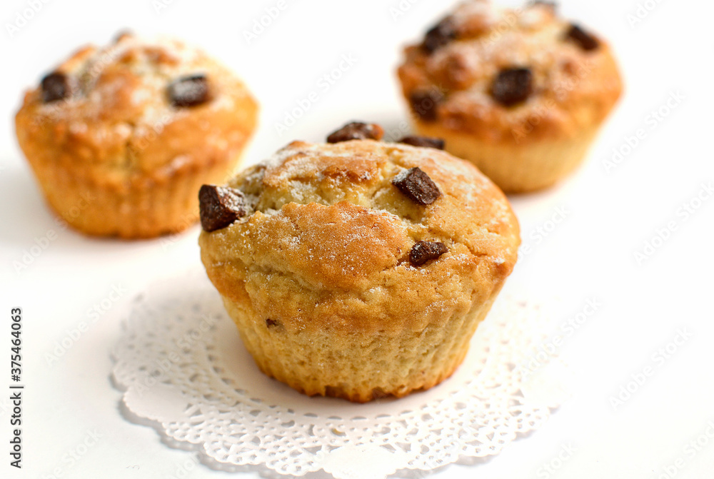 Close-up of homemade cupcakes with chocolate chips on a white Close-up of homemade cupcakes with chocolate chips on a white