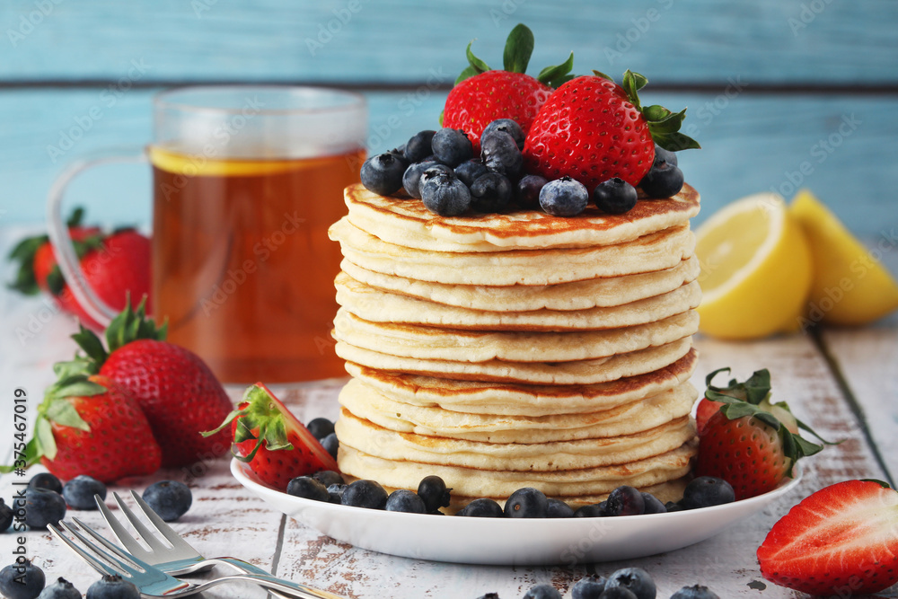 A stack if home-made pancakes with berry A stack if home-made pancakes with berry