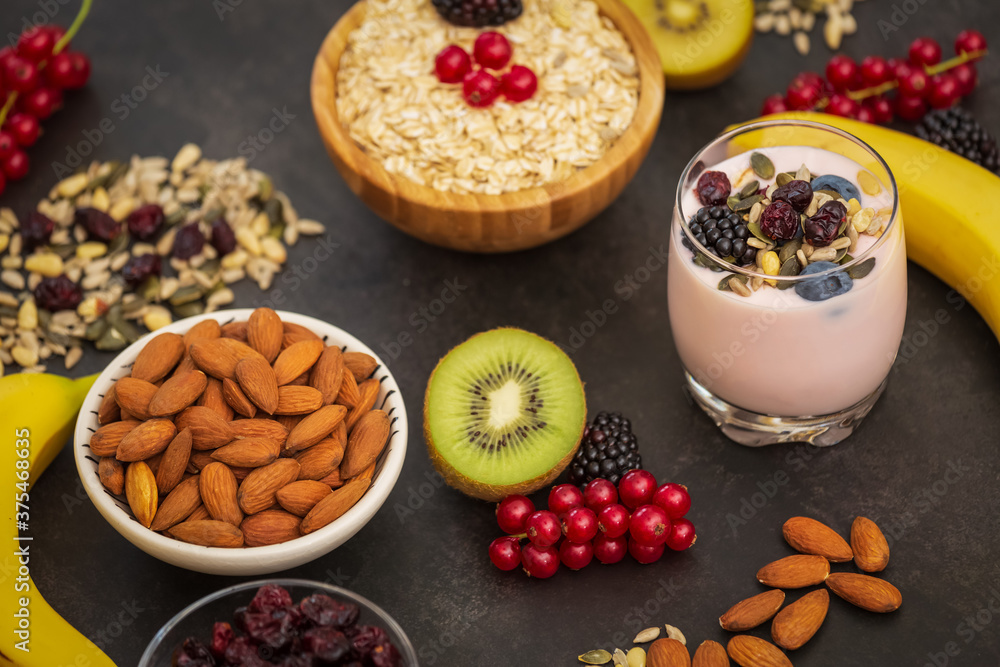 Group Fruits Breakfast with bread Whole grains and nuts, yogurt mix with Cherry , banana, avocado in the wooden table. Breakfast for Health and Diet concept Group Fruits Breakfast with bread Whole grains and nuts, yogurt mix with Cherry , banana, avocado in the wooden table. Breakfast for Health and Diet concept