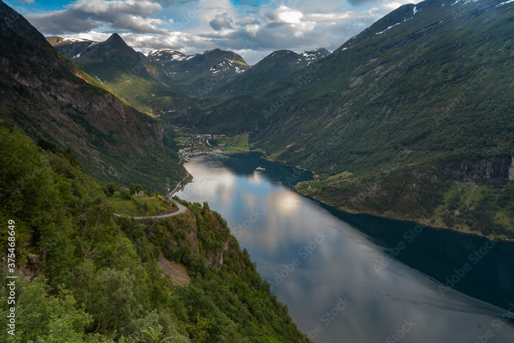 Scenic view of the Geiranger Fjord, Norway. A spectacular, narrow finger of the Sunnylvsfjorden, a branch of the Storfjorden. Geiranger village is located at the end of the fjord