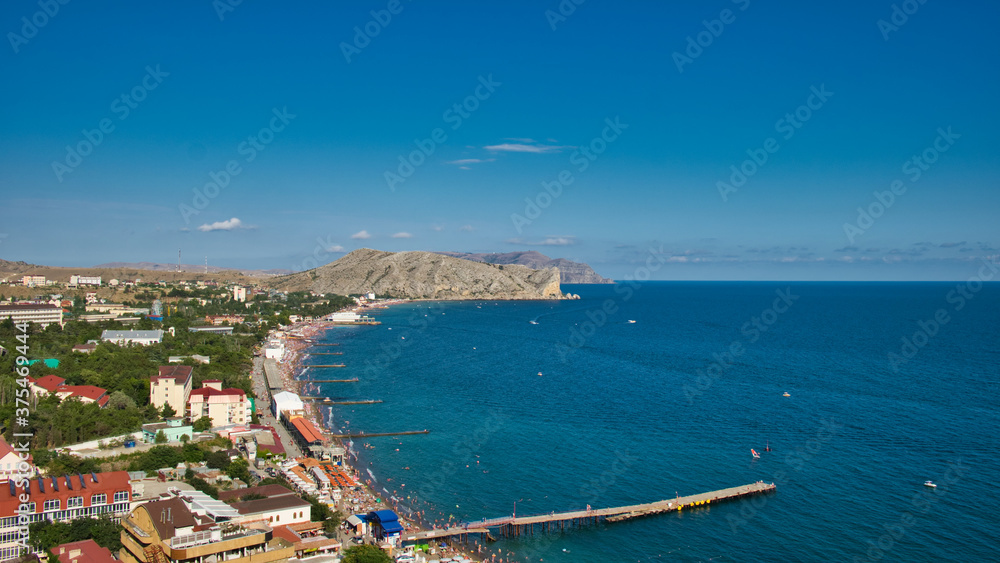 The Sudak Bay at summer, Crimea. The crowds of people on the beach.