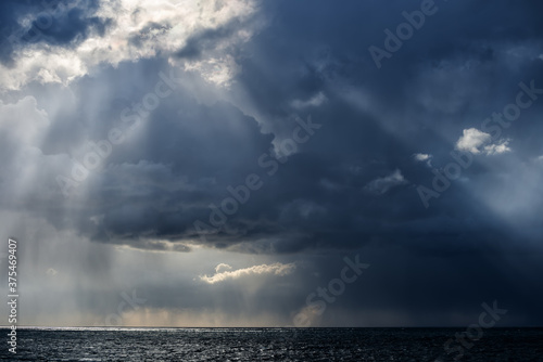 Autumn storm over the Black sea with rain and sun rays