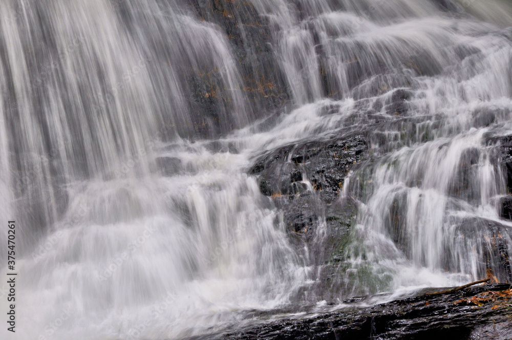 Closeup of white curtains of water plunging down scenic Garwin Falls in Wilton, New Hampshire. Closeup of white curtains of water plunging down scenic Garwin Falls in Wilton, New Hampshire.